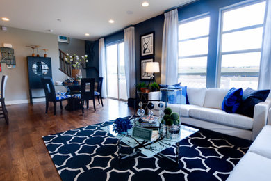 Example of a mid-sized classic formal and open concept dark wood floor and brown floor living room design in Philadelphia with blue walls, no fireplace and no tv