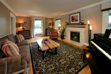 This is an example of a small traditional enclosed living room in Columbus with a reading nook, beige walls, medium hardwood flooring, a standard fireplace, a stone fireplace surround and no tv.