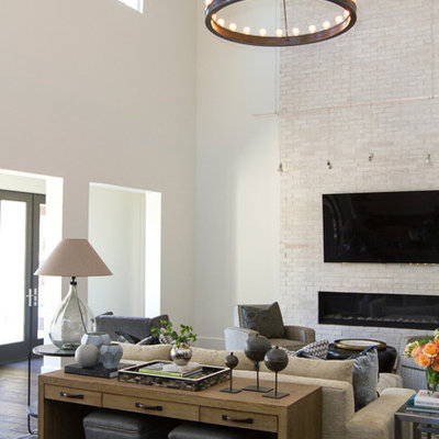 Transitional dark wood floor living room photo in Jacksonville with white walls, a ribbon fireplace, a brick fireplace and a wall-mounted tv