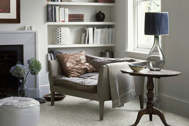 Inspiration for a mid-sized timeless enclosed carpeted living room library remodel in Other with beige walls