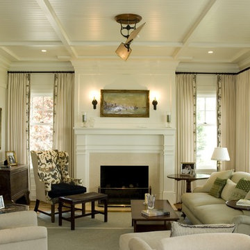 Living room with raised paneling + coiffured ceiling with bead board