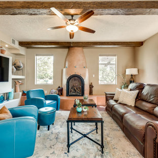 Small southwest open concept brick floor and red floor living room photo in Albuquerque with brown walls, a plaster fireplace and a media wall