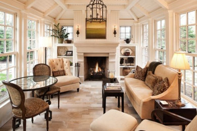 This is an example of a medium sized traditional living room in Orange County with light hardwood flooring, a standard fireplace, a concrete fireplace surround and beige floors.