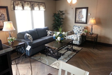 This is an example of a medium sized enclosed living room in Atlanta with beige walls and medium hardwood flooring.