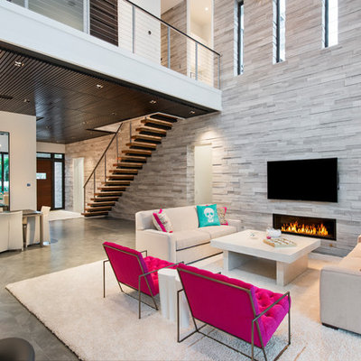 Inspiration for a contemporary open concept gray floor living room remodel in Miami with gray walls, a ribbon fireplace and a wall-mounted tv