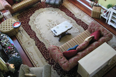 Huge enclosed medium tone wood floor living room photo in Orange County