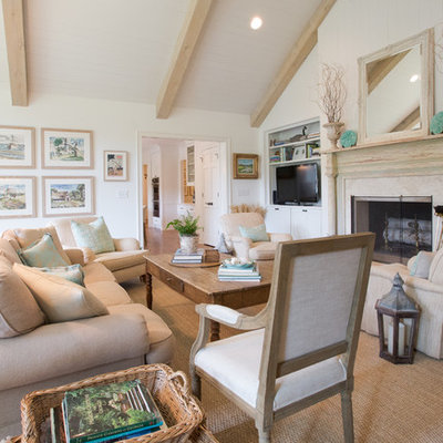 Example of a farmhouse medium tone wood floor living room design in Atlanta with white walls and a standard fireplace