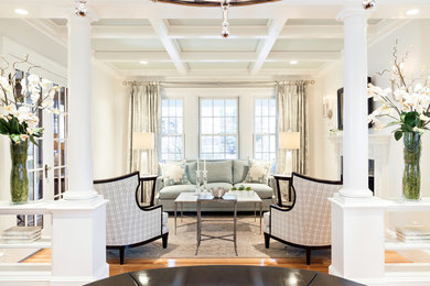 Example of a large classic formal and enclosed medium tone wood floor living room design in Boston with white walls, a standard fireplace and no tv