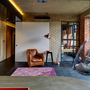 Design ideas for an industrial living room in London with beige walls, dark hardwood flooring and black floors.