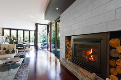 Inspiration for an industrial living room remodel in Montreal with a concrete fireplace
