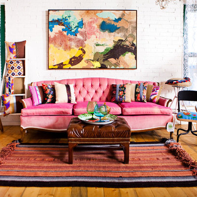 Inspiration for an eclectic medium tone wood floor living room remodel in Denver with white walls