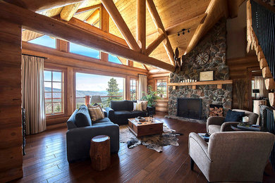 Example of a large mountain style formal and open concept dark wood floor living room design in Vancouver with brown walls, a standard fireplace, a stone fireplace and no tv