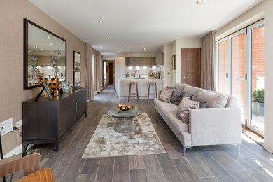 Inspiration for a large contemporary open plan living room in London with white walls, porcelain flooring and brown floors.