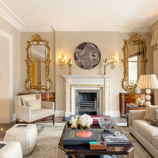 Medium sized traditional formal living room in Other with beige walls, dark hardwood flooring, a standard fireplace and brown floors.