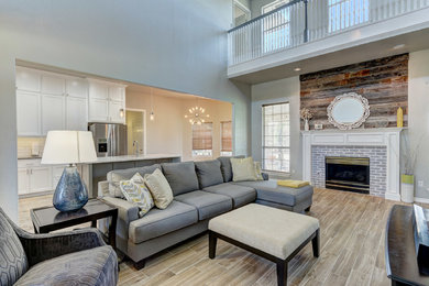 Example of a mid-sized classic formal and loft-style porcelain tile living room design in Oklahoma City with white walls, a standard fireplace and a brick fireplace