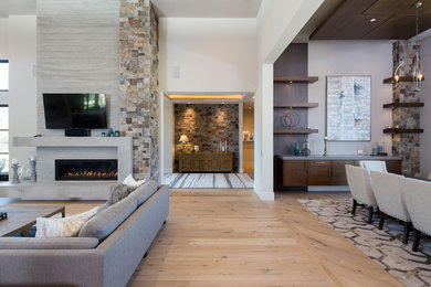 Inspiration for a mid-sized contemporary formal and open concept light wood floor and beige floor living room remodel in Sacramento with white walls, a ribbon fireplace, a concrete fireplace and a wall-mounted tv
