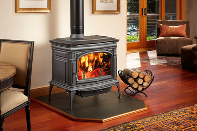 Example of a mountain style living room design in Boston with a wood stove and a metal fireplace