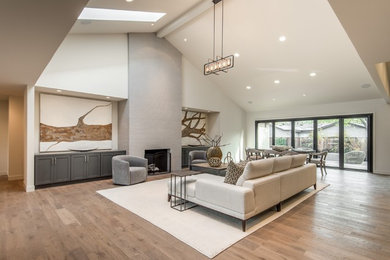 Large trendy formal and open concept light wood floor living room photo in San Francisco with beige walls, a standard fireplace and a tile fireplace