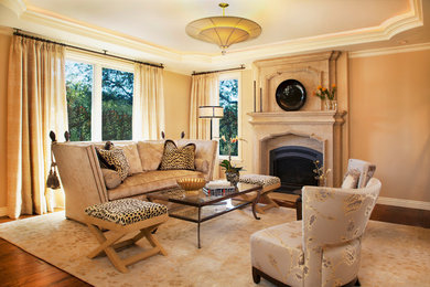 Example of a large classic open concept and formal medium tone wood floor living room design in San Francisco with white walls, a standard fireplace and a plaster fireplace