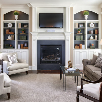 Elegant formal dark wood floor living room photo in Louisville with beige walls, a standard fireplace and a wall-mounted tv