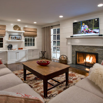 Mid-sized transitional enclosed dark wood floor living room photo in Boston with white walls, a standard fireplace, a stone fireplace and a wall-mounted tv