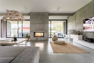 Large trendy open concept concrete floor, gray floor, coffered ceiling and wall paneling living room photo in Phoenix with gray walls, a hanging fireplace, a concrete fireplace and a wall-mounted tv