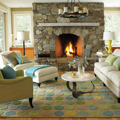 Mid-sized beach style enclosed and formal medium tone wood floor and brown floor living room photo in Boston with beige walls, a standard fireplace, a stone fireplace and no tv
