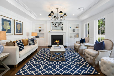Large nautical formal open plan living room in Sydney with white walls, a standard fireplace, a concrete fireplace surround, dark hardwood flooring, brown floors, a drop ceiling and panelled walls.