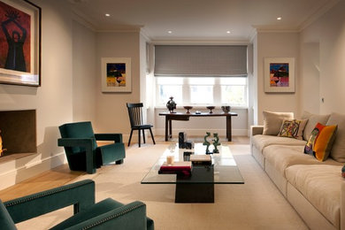 Photo of a large classic formal living room in London with white walls, medium hardwood flooring and a standard fireplace.