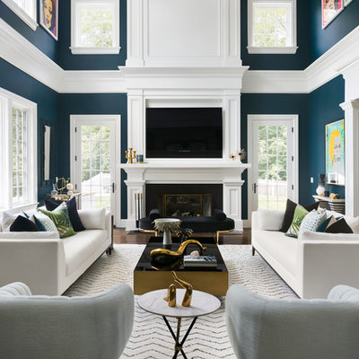 Example of a transitional formal and open concept medium tone wood floor and brown floor living room design in New York with blue walls, a standard fireplace and a wall-mounted tv