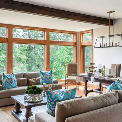 Large cottage formal medium tone wood floor living room photo in Montreal with gray walls, no tv, a standard fireplace and a stone fireplace