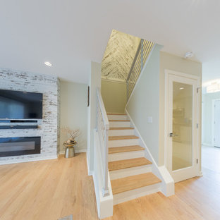Inspiration for a mid-sized contemporary open concept and formal light wood floor and brown floor living room remodel in Chicago with white walls, a wood fireplace surround, a media wall and a ribbon fireplace