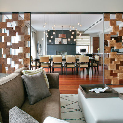 Inspiration for a mid-sized contemporary medium tone wood floor living room remodel in New York with white walls, a standard fireplace and a concrete fireplace