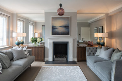 Medium sized traditional living room in London with grey walls, dark hardwood flooring, a standard fireplace, a stone fireplace surround and grey floors.