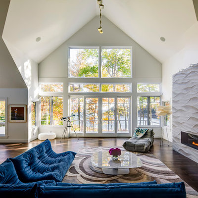 Living room - large contemporary formal and open concept living room idea in Portland Maine with a ribbon fireplace, white walls and a plaster fireplace