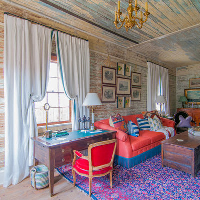 Example of an eclectic formal and enclosed medium tone wood floor living room design in New Orleans with multicolored walls
