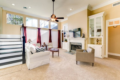 Example of a mid-sized transitional open concept carpeted living room design in New Orleans with beige walls, a standard fireplace, a tile fireplace and a tv stand