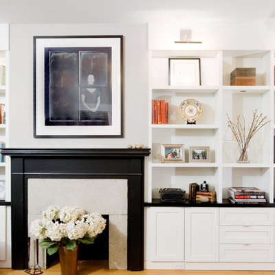 Example of a minimalist living room library design in Vancouver with a standard fireplace