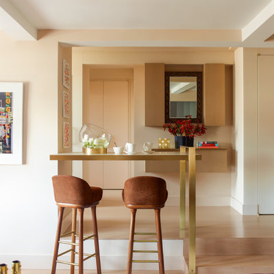 Example of a trendy medium tone wood floor living room design in New York with beige walls