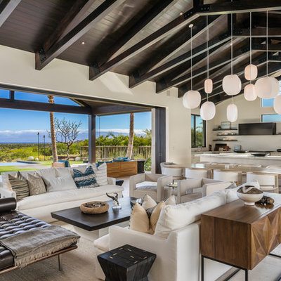 Living room - tropical open concept gray floor living room idea in Other with white walls