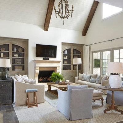 Example of a large country open concept medium tone wood floor living room library design in Atlanta with white walls, a standard fireplace, a stone fireplace and a wall-mounted tv