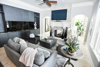 Photo of a medium sized traditional formal enclosed living room in Chicago with grey walls, travertine flooring, a two-sided fireplace, a stone fireplace surround, beige floors and a wall mounted tv.