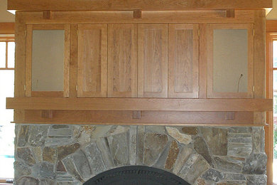 低価格の小さなトラディショナルスタイルのおしゃれなリビング (ベージュの壁、無垢フローリング、標準型暖炉、石材の暖炉まわり、テレビなし、茶色い床) の写真