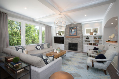 Example of a large transitional formal and open concept dark wood floor living room design in Minneapolis with white walls, a standard fireplace, a brick fireplace and a media wall