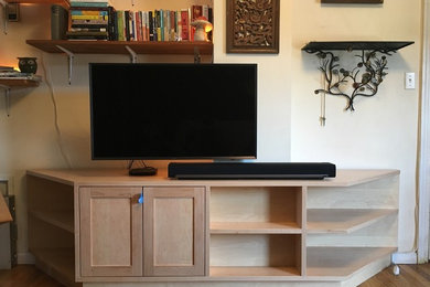 Example of a mid-sized classic formal and enclosed dark wood floor and brown floor living room design in New York with beige walls, no fireplace and a wall-mounted tv