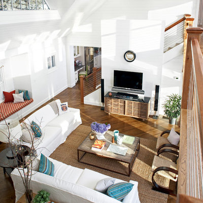 Inspiration for a large coastal open concept medium tone wood floor living room remodel in Boston with white walls and a wall-mounted tv