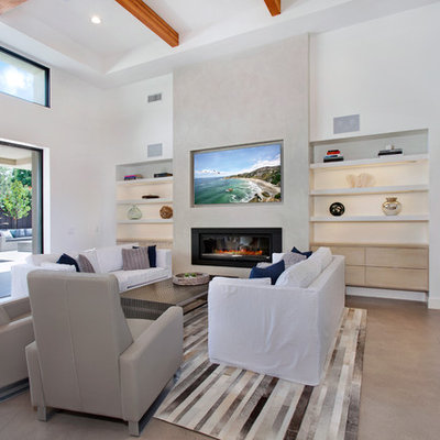 Inspiration for a mid-sized contemporary open concept concrete floor living room remodel in Orange County with a bar, beige walls, a standard fireplace, a plaster fireplace and a media wall