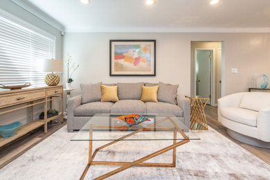 Example of a small trendy open concept vinyl floor and gray floor living room design in Cleveland with gray walls, no fireplace and a wall-mounted tv
