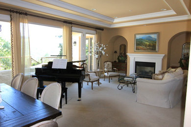 Example of a large classic open concept carpeted living room design in San Francisco with beige walls, a standard fireplace, a wood fireplace surround, a music area and no tv