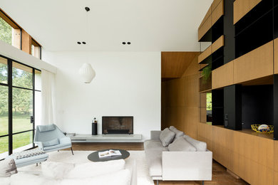 Foto de salón abierto moderno de tamaño medio sin televisor con paredes blancas, suelo de madera en tonos medios, todas las chimeneas, marco de chimenea de ladrillo y suelo marrón